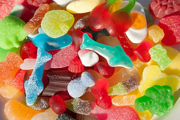 A colorful variety of sugar-coated gummy candies and pick n mix sweets.