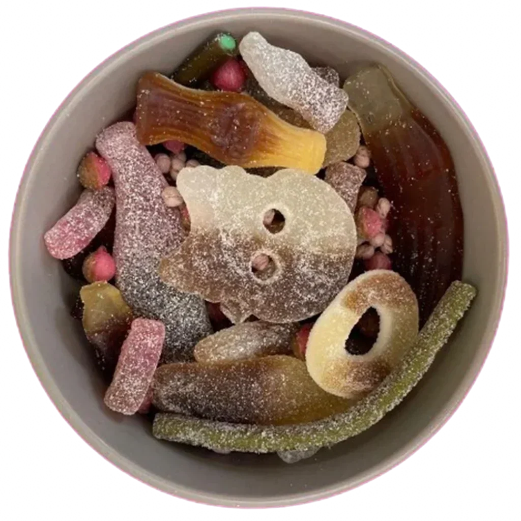 A bowl filled with a variety of sugar-coated gummy sweets and candies.