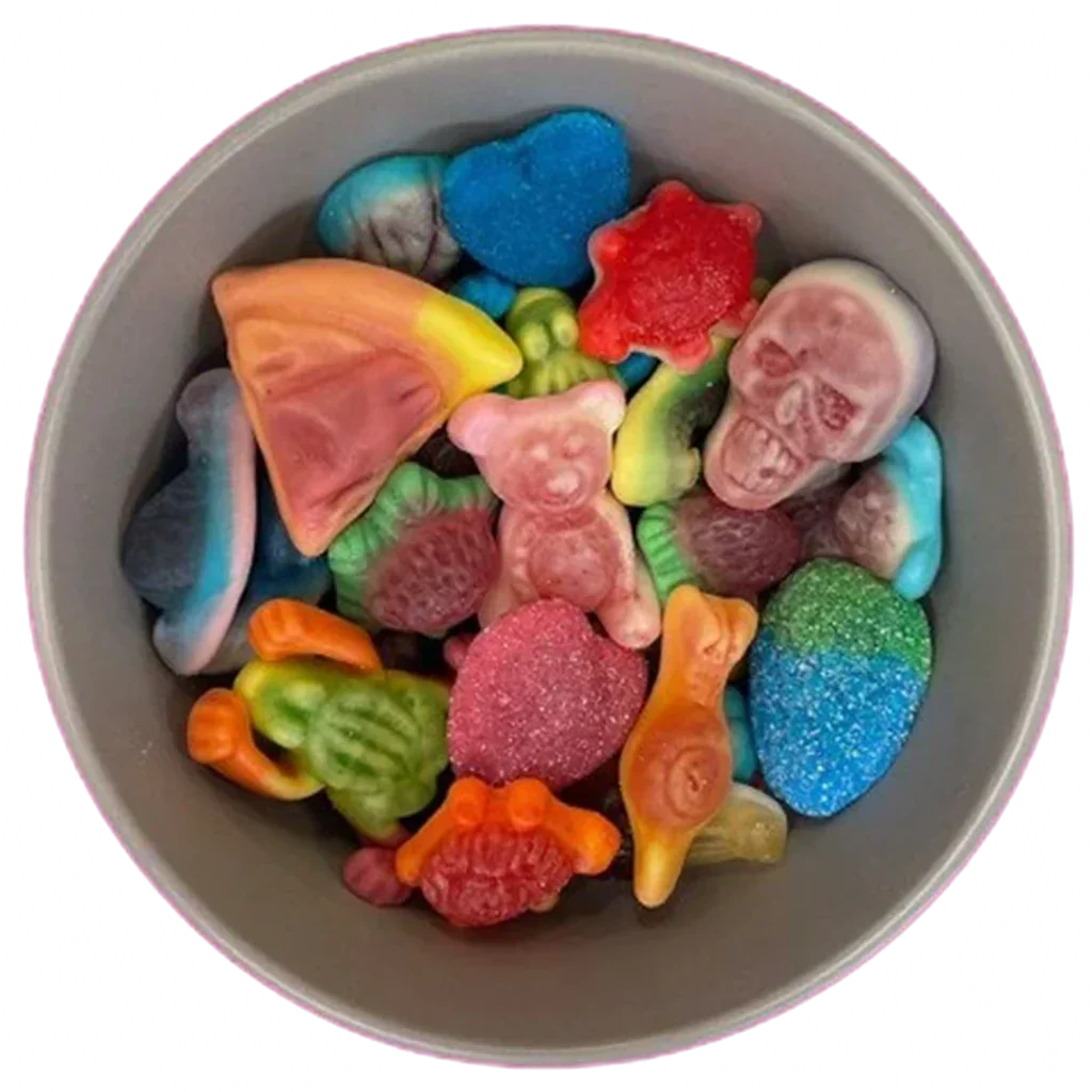 A grey bowl filled with a variety of colorful gummy pick n mix sweets on a pink background.